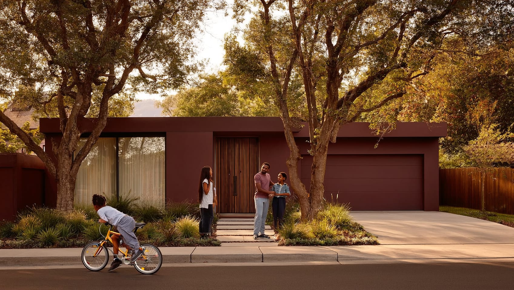 Family greeting their advisor outside a contemporary home on a tree-lined residential street