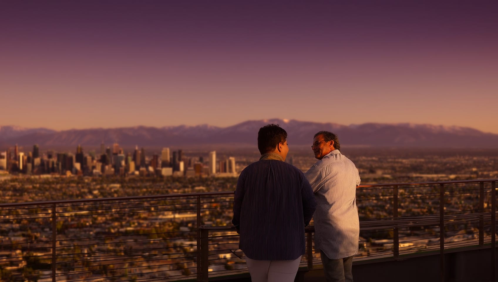Investors overlooking a western Canadian downtown skyline at golden hour